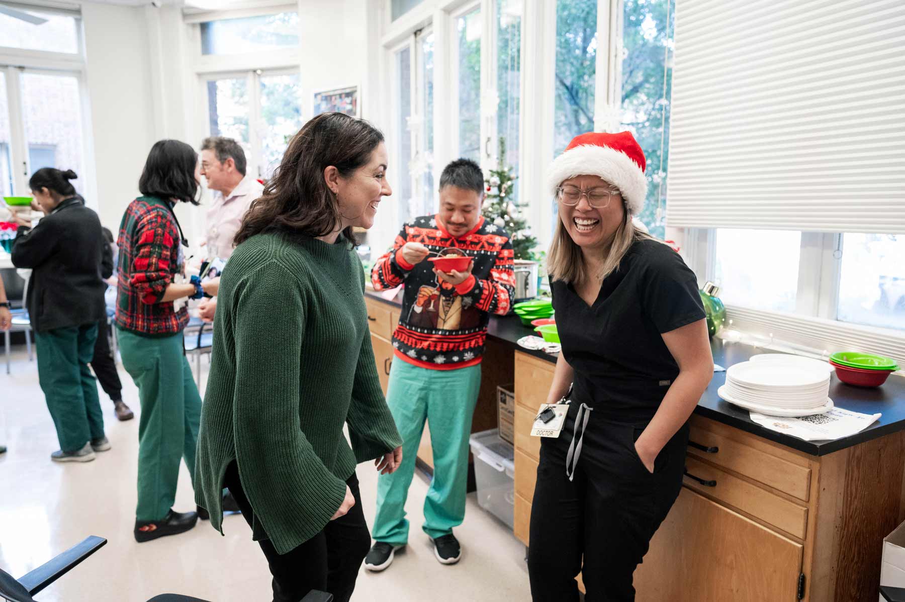 Larissa Thomas and her colleague Amy Ou share a laugh at the Zuckerberg San Francisco General Hospital holiday party.