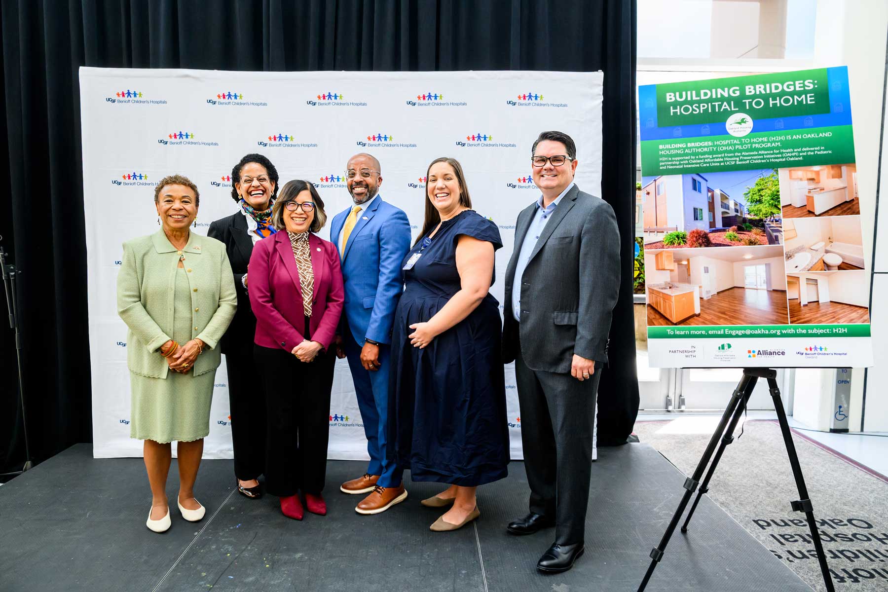 A group photo of officials from the local Oakland and Alameda governments, representatives from U C S F Benioff Children's Hopsital Oakland, and representatives from the Alameda Alliance for Health.