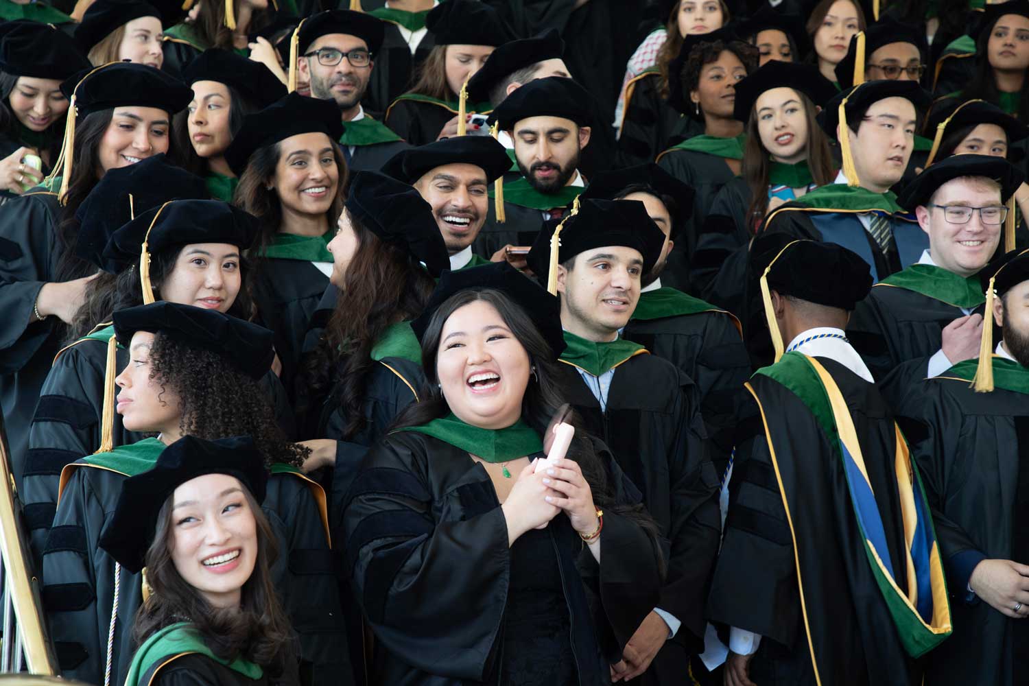 Members of the UCSF School of Medicine Class of 2026 prepare for a class photo.