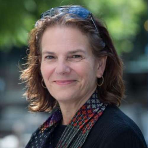 Kristine Yaffe smiles in outdoor courtyard.