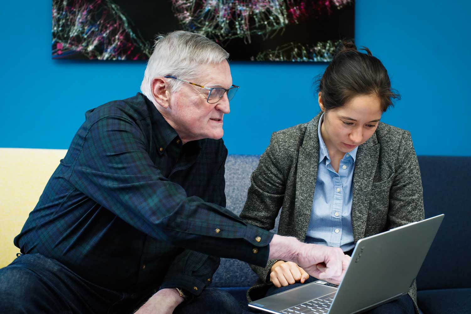 Robert Knight and Clara Starkweather look at a laptop.