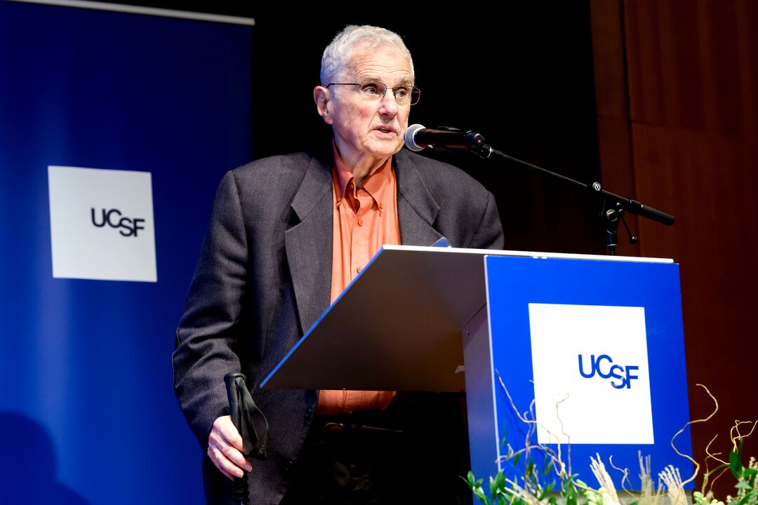 Bruce Alberts speaks at a podium.