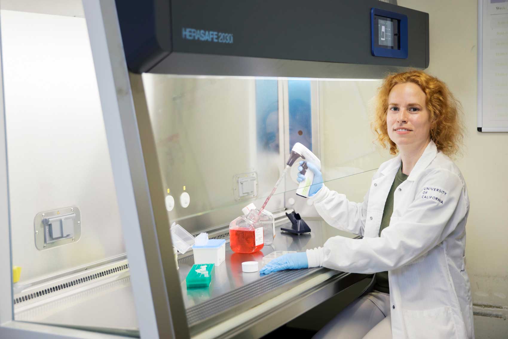 Hanna Martens wears a lab coat while working in her lab.
