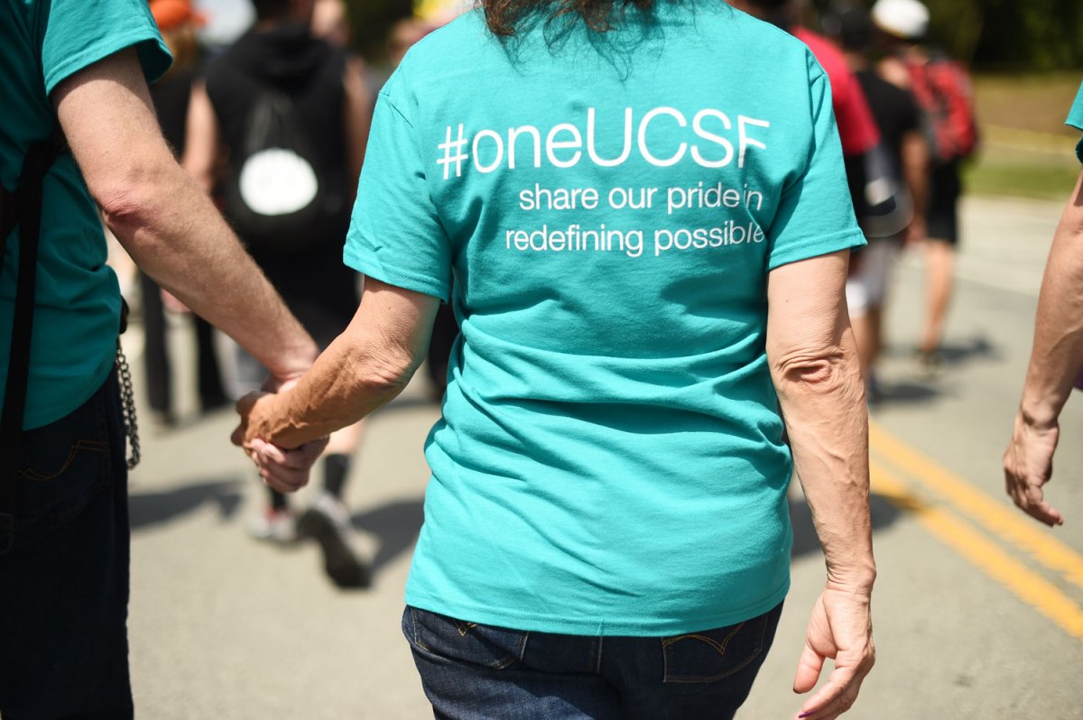 Cyan color t-shirt with white text "#oneUCSF share our pride inredefining possible".