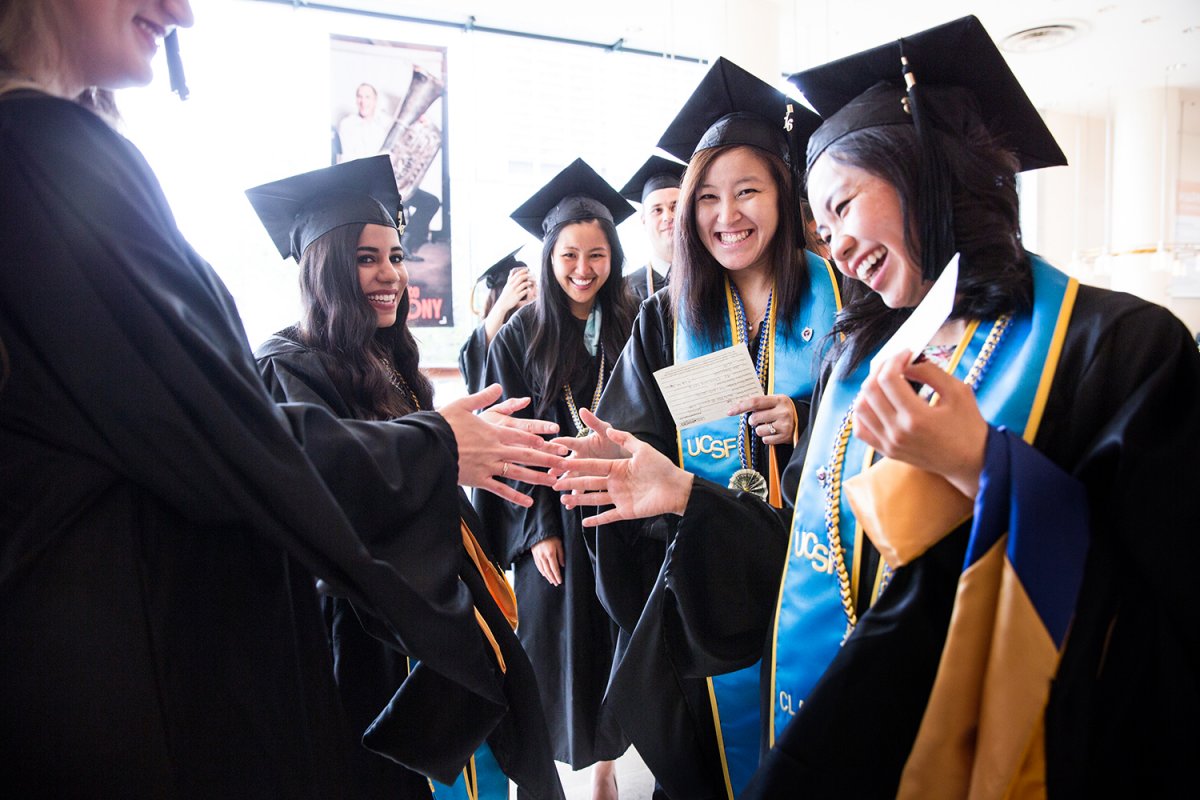 UCSF School of Dentistry Dental Hygeine graduates celebrate with one another after their commencement ceremony.