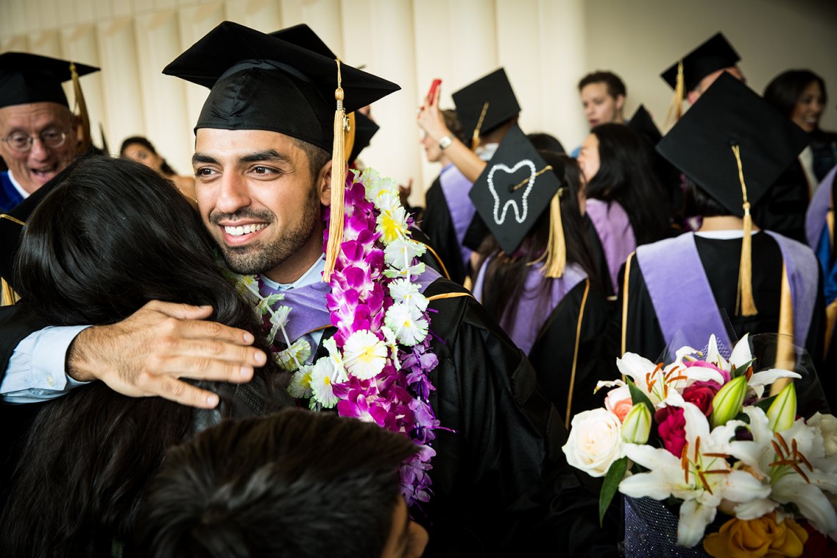 School of Dentistry graduate Omid Ebrahimi receives a hug after the commencement ceremony.