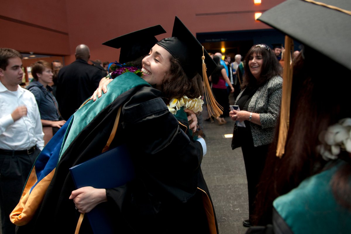 Fellow graduates show their happiness at achieving a major milestone in higher education.