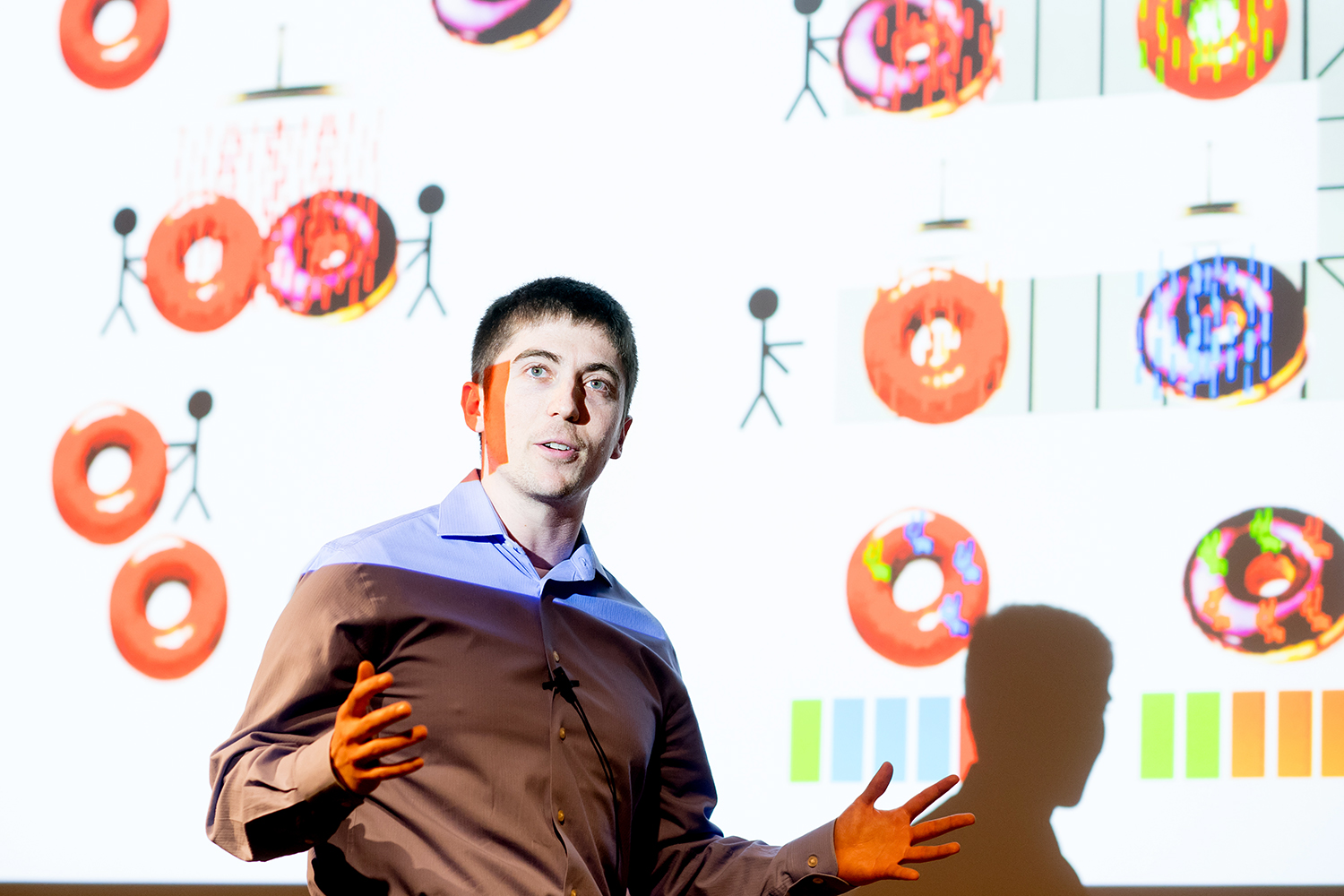 Sam Pollock, who won the people’s choice award, delivers his talk on antibody therapy for tumors that had an extended metaphor on doughnut glazes and the sprinkles that stick to them.