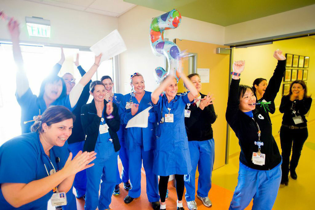 Medical staff of UCSF Benioff Children's Hospital giving a cheerful welcome to a patient.