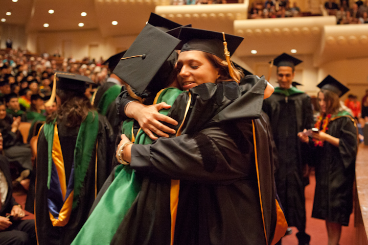 Classmates hug each other as they rejoice after the commencement ceremony.
