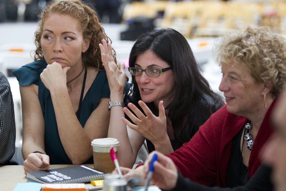 Kate Rakin, left, a neurology researcher at UCSF, listens to the team discussion with Laura van 't Veer, right, a molecular pathologist who specializes in breast cancer.