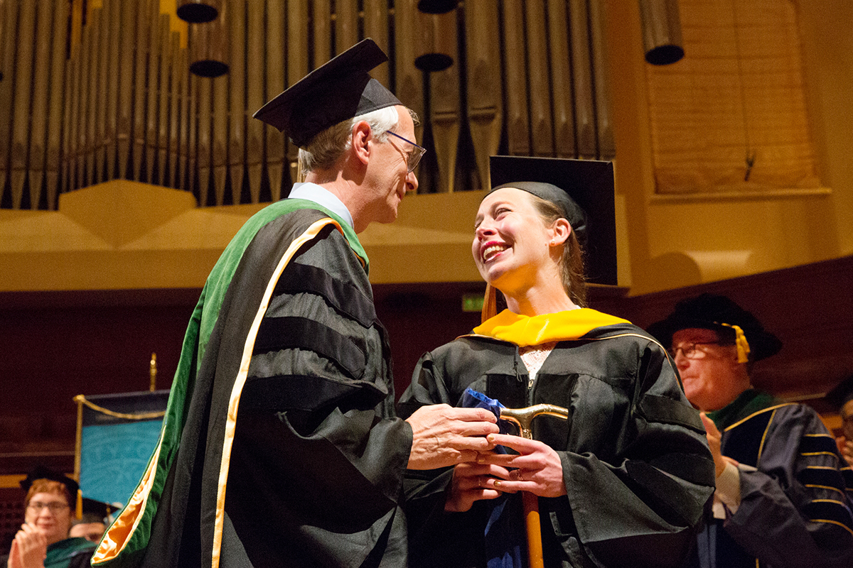 Kenneth McQuaid, (left) MD, presents this year’s Gold-Headed Cane Award to Elizabeth McNiven, MD. The cane was bequeathed by David L. Coleman, MD. The cane is presented annually to a graduating senior who has been selected by classmates and the faculty as best exemplifying the qualities of a "true physician."