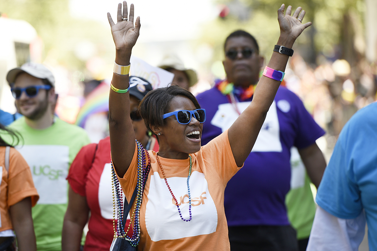 A member of UC San Francisco's contingent in the San Francisco Pride Parade waves to the crowd during Sunday's event.
