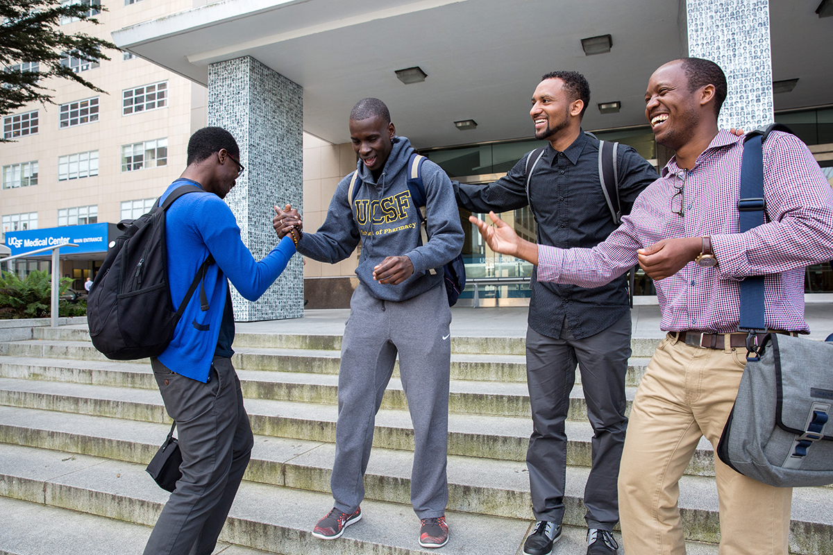 Henock Woldu (second from right) laughs with his School of Pharmacy classmates who have all, like Woldu, emigrated to the U.S. from countries in Africa. From left, Micah Ahazie, a second-year student from Nigeria; Cheick Diarra, a third-year student from Mali; and Theo Ndatimana, MPH, a second-year student from Rwanda. 