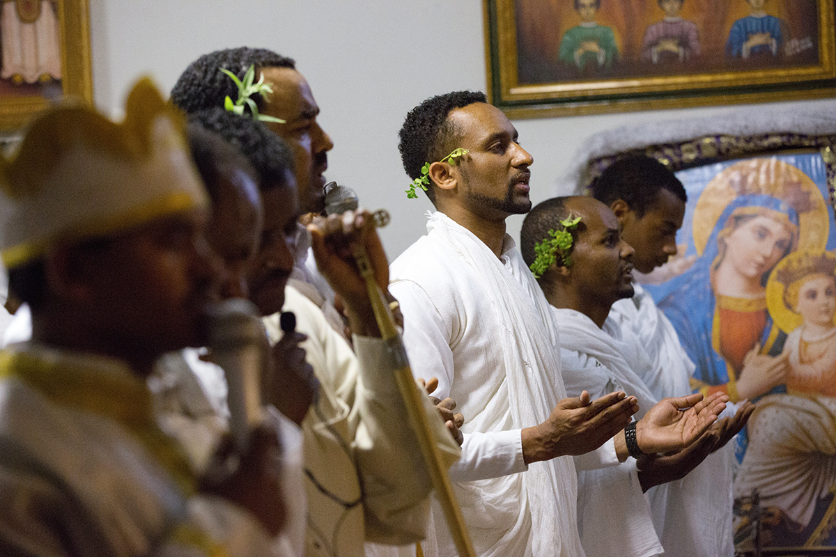 Several days before receiving his Doctor of Pharmacy degree, Henock Woldu, a devout Orthodox Christian from Ethiopia, participates in an Easter service in his hometown San Jose