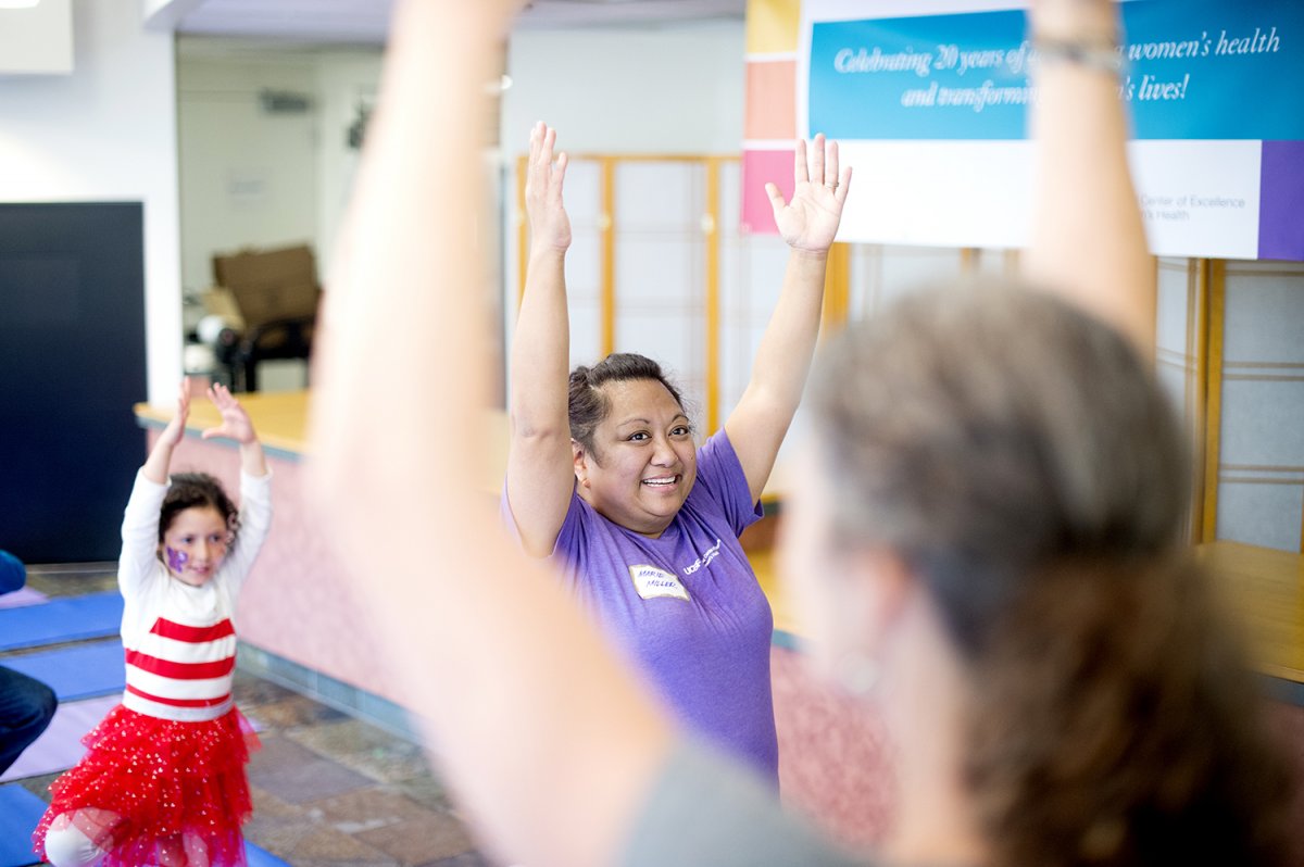 Marie Miller participates in a yoga class during the 20th anniversary celebration of the UCSF National Center of Excellence in Women’s Health at Mount Zion.