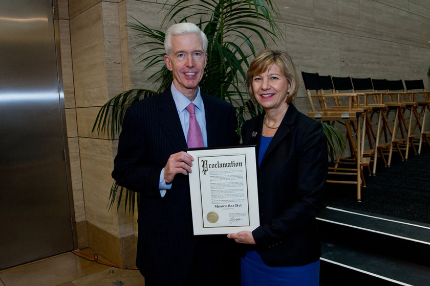 Former Gov. Gray Davis and UCSF Chancellor Susan Desmond-Hellmann, MD, MPH, hold a proclamation awarded by the City and County of San Francisco on the 10th anniversary of UCSF Mission Bay, that Jan. 23, 2013, was “Mission Bay Day.”