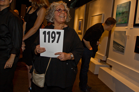 Lisa Roth, a graphic artist and project manager for Art for AIDS, bids on artwork during the live auction.