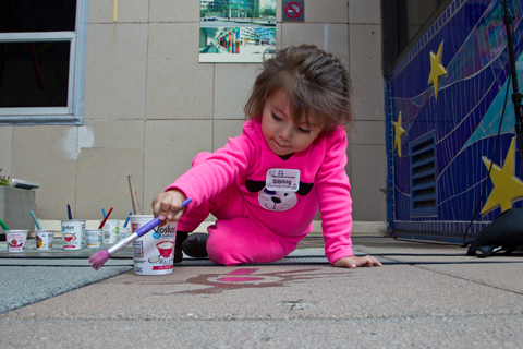 Three-year-old Destiny Sanchez, a sibling of a UCSF patient, explores with sidewalk painting.