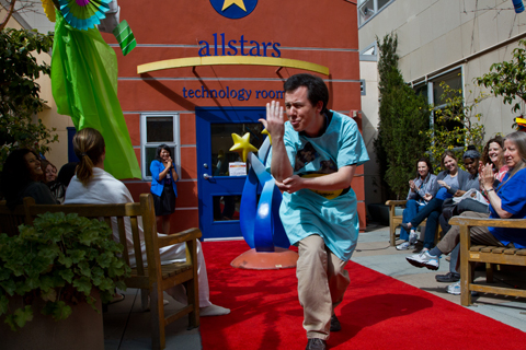 UCSF Child Life teacher Andrei Massenkoff shows off WWE wrestler John Cena’s signature “You Can’t See Me” move while wearing a wrestling-inspired designed hospital gown.
