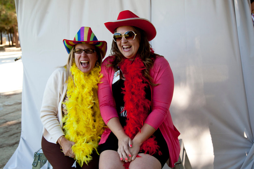 Bioengineering graduate program administrator Sarah Jane Taylor, left, and Kylie Ball share a laugh at the photo booth at the UCSF Graduate Division's celebration 