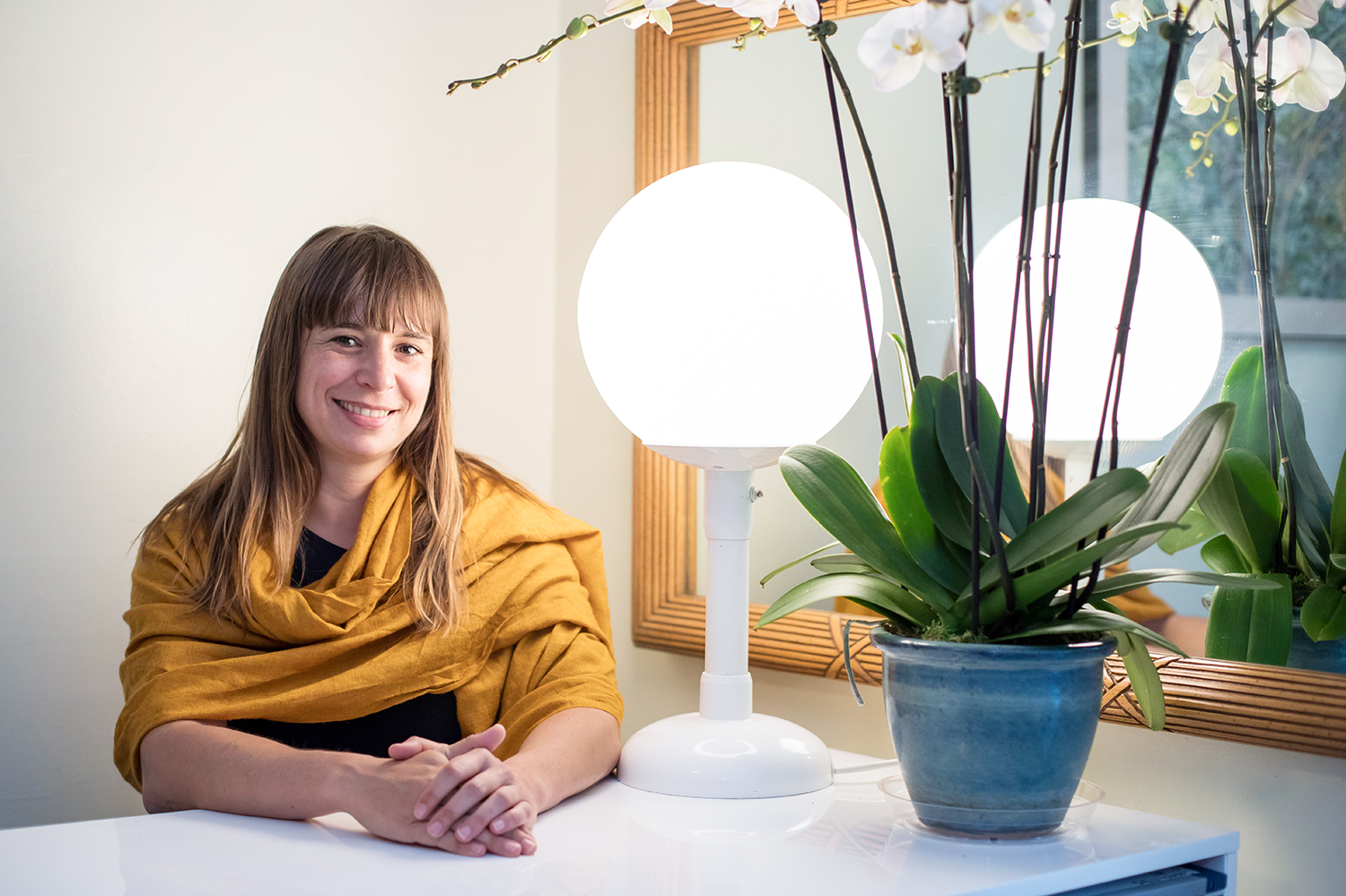 Eve Ekman sits next to a lamp by which her father used to read people's facial expressions