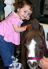 Olivia Ross, 2, shows her excitement petting Thumbelina
