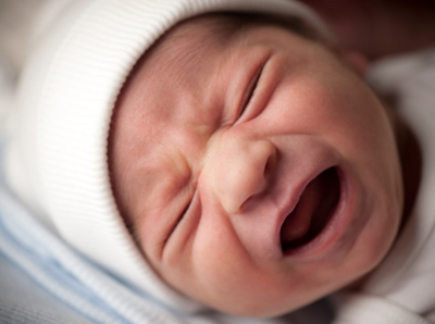 Stock image of a colicky newborn baby boy