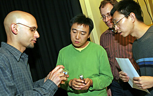 Director of the UCSF Nikon Imaging Center, Kurt Thorn (far left), explains the functions of one of the six advanced optical microscopes available to UCSF researchers.