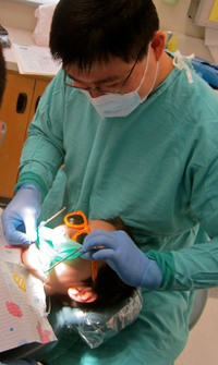 Brent Lin, DMD, examines patient