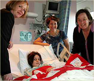 Lisa Honig Buksbaumm, third from left, visits Jennifer Reyff and her mother Sydney