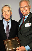 CEO Mark Laret accepts the award on behalf of the medical center with Arnold Milstein.