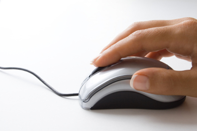 Stock photo of woman's hand on computer mouse