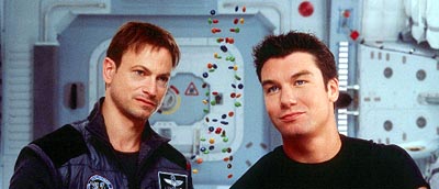 Jim McConnell (Gary Sinise) and Phil Ohlmyer (Jerry O'Connell) study a DNA model