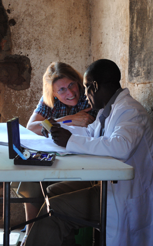 Ellen Schell talks with a clinical officer in Malawi.