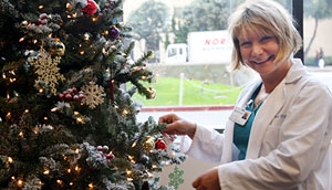 Judith Pekala hangs an ornament on the tree