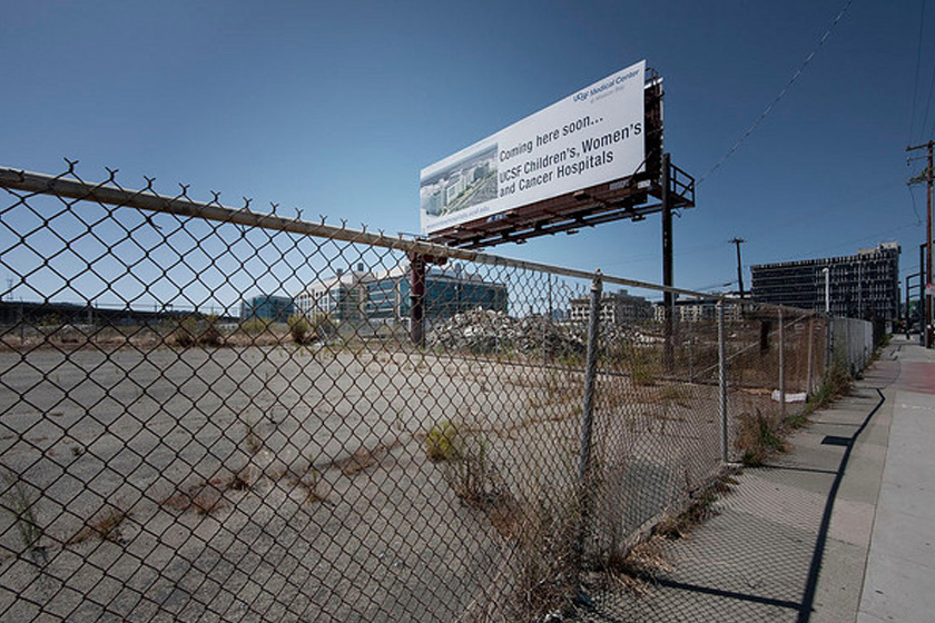 A billboard with the logo of UCSF Medical Center and text "Comming here soon...UCSF Children's, Women's and Cancer Hospitals"