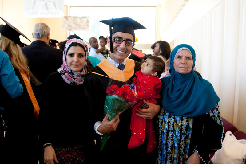Nursing School graduate Hamza Alduraidi is congratulated by his sister Hana, 9-month-old niece Noor, and mother Nadeah after the commencement ceremony.