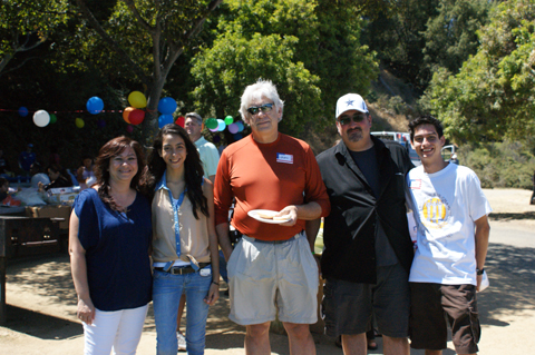 John Roberts, MD, UCSF professor of surgery and chief of the Division of Transplantation, center, enjoys the picnic festivities with other attendees.