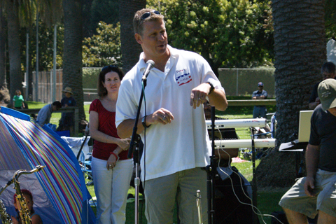 Swimmer Mark Henderson, who won gold at the 1996 Atlanta Olympics in the 4x100 medley relay, speaks to the crowd.