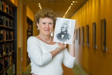 Suzanne Carlisle Vick holds a photo of her ancestor Hugh Toland, who founded Toland Medical College, which eventually became UCSF.