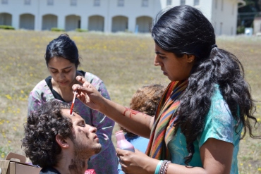 A HEAL Initiative fellow treats a head wound of a volunteer pretending to be injured during a training exercise