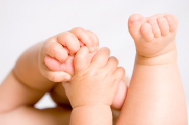 Baby holding its feet