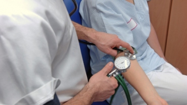 Male nurse checking blood pressure