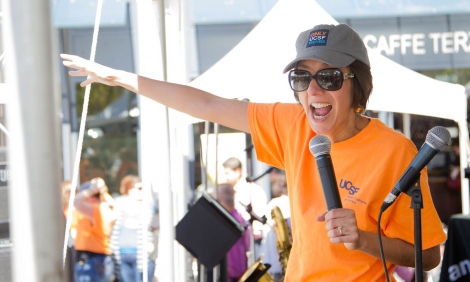 Lisa Cisneros, senior director of strategic communications at University Relations, rallies the crowd at Mission Bay Block Party 8.