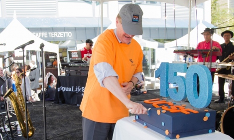 Chancellor Sam Hawgood cuts the 150th Anniversary cake at Mission Bay Block Party 8.