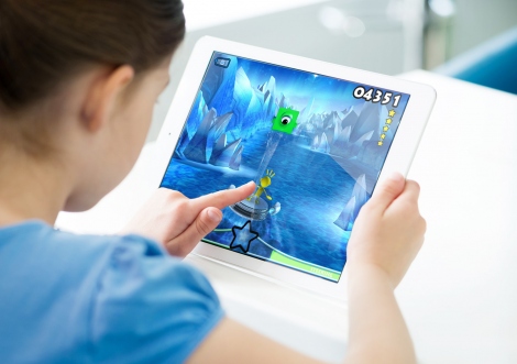 a child plays the EVO video game on a tablet