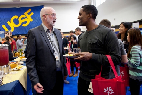 John Featherstone speaks with Tsegazeab Gessese at the 2014 Chancellor’s Reception and New Student Orientation Fair