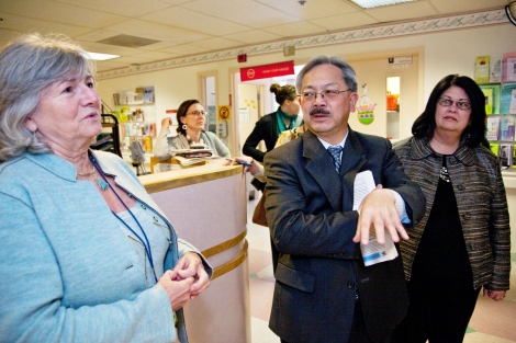 Sue Carlisle, Ed Lee, and Sue Currin talk inside San Francisco General Hospital