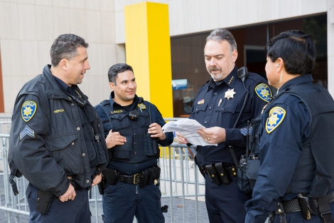 UCSF Police Department Chief Mike Denson talks with three other officers